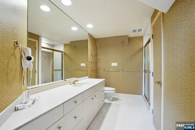 a spacious bathroom with a double vanity sink mirror and shower
