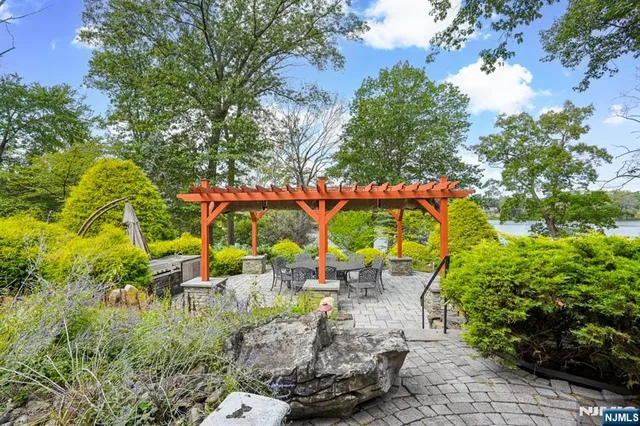 a backyard of a house with a yard and outdoor seating