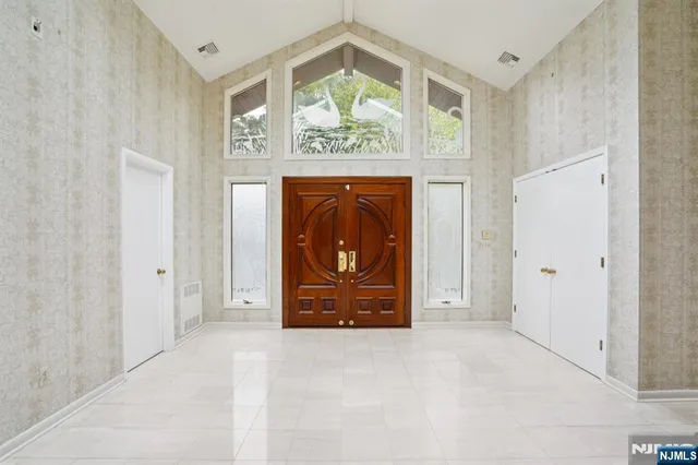 a view of an entryway with a wooden door