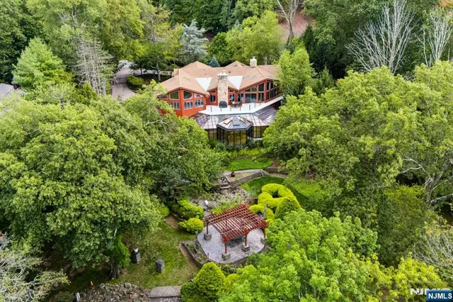 an aerial view of a house with a swimming pool and garden view