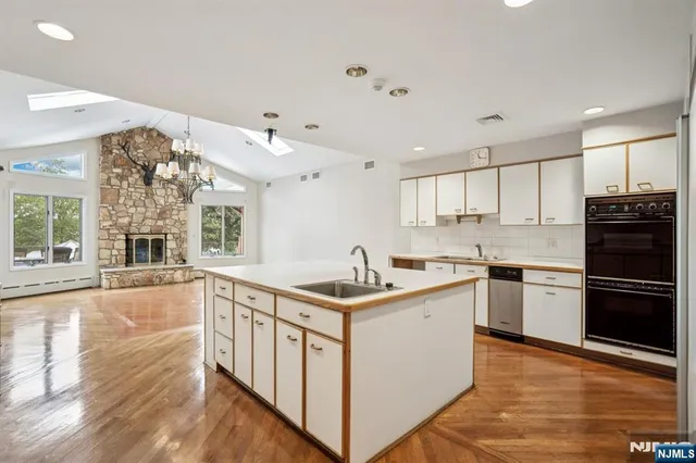 a kitchen with stainless steel appliances granite countertop a stove and a sink
