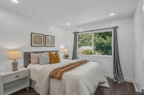 a bedroom with a large bed and a window