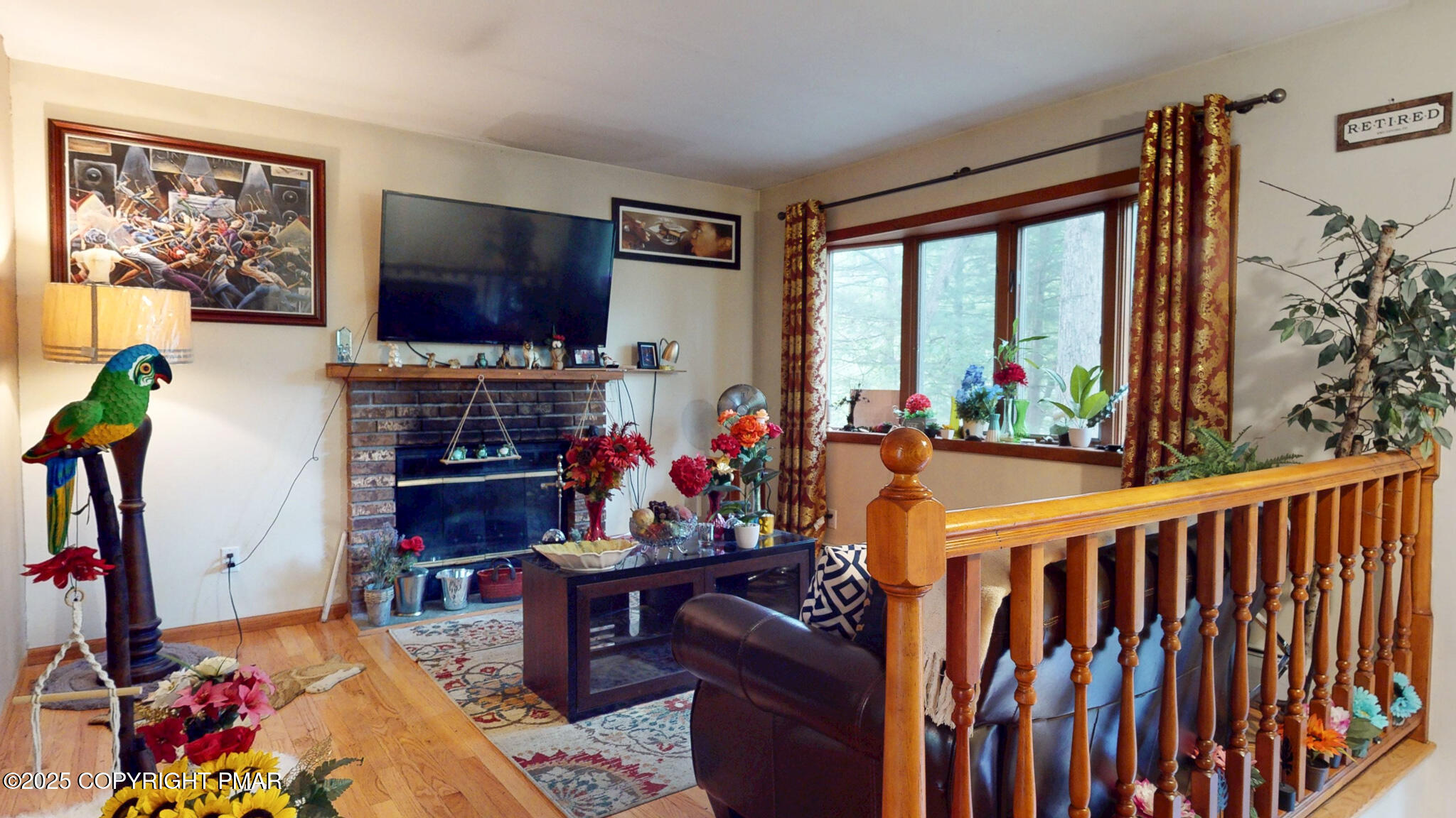 619 Rimrock Road Bartonsville, PA 18321 - Photo 17 of 65 a living room with furniture a flat screen tv and a floor to ceiling window
