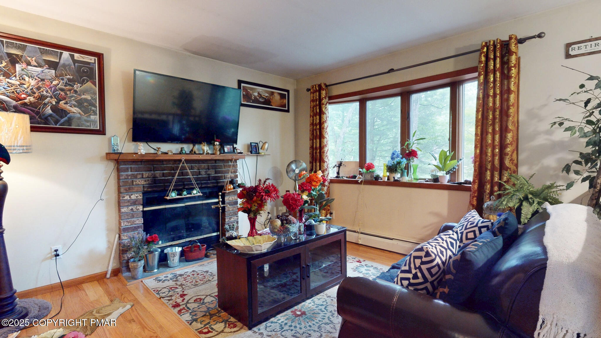 619 Rimrock Road Bartonsville, PA 18321 - Photo 22 of 65 a living room with furniture a flat screen tv and a fireplace