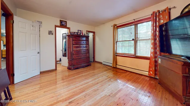 a view of an empty room and wooden floor