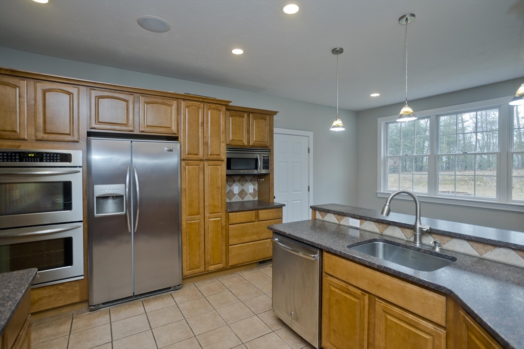 59 James Road Ware, MA 01082 - Photo 13 of 42 a kitchen with granite countertop a sink stainless steel appliances and cabinets