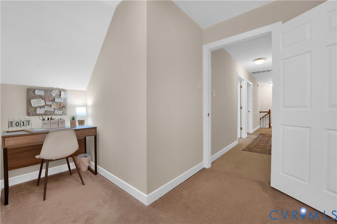 16148 Buckfast Place Beaverdam, VA 23015 - Photo 26 of 48 a view of a hallway to a livingroom with furniture and wooden floor
