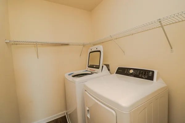 an empty room with windows and ceiling fan