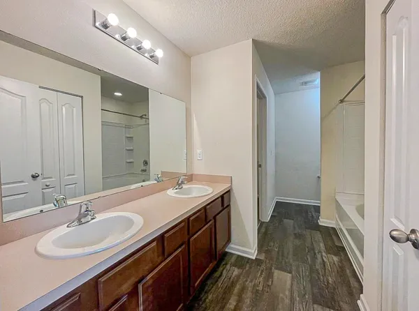 a white toilet sitting next to a sink