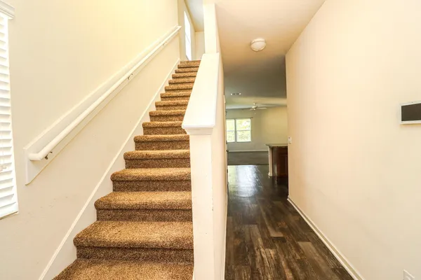 a view of entryway and hall with wooden floor