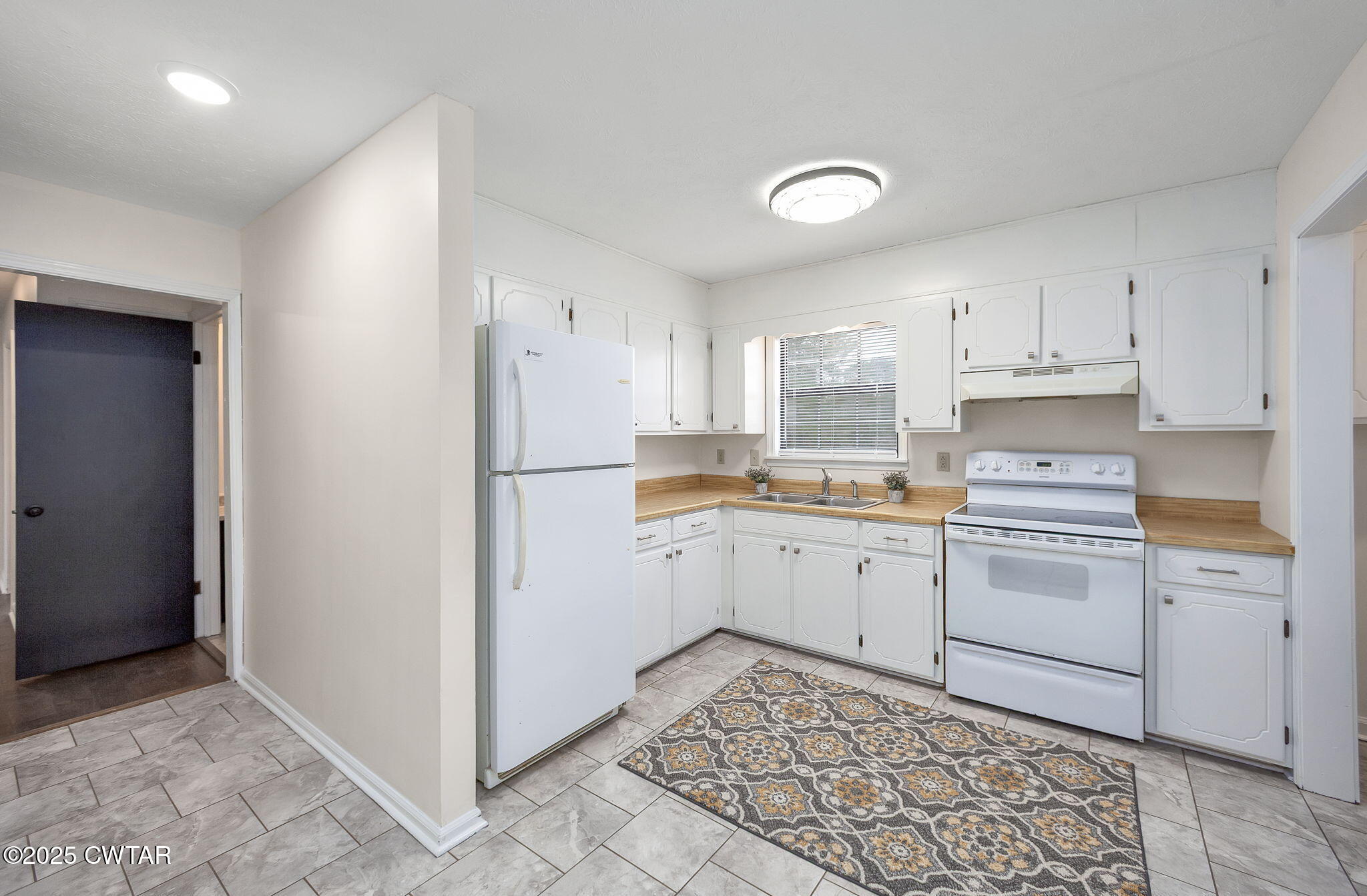 21 Carol Road Huron, TN 38345 - Photo 21 of 29 a kitchen with white cabinets and white appliances