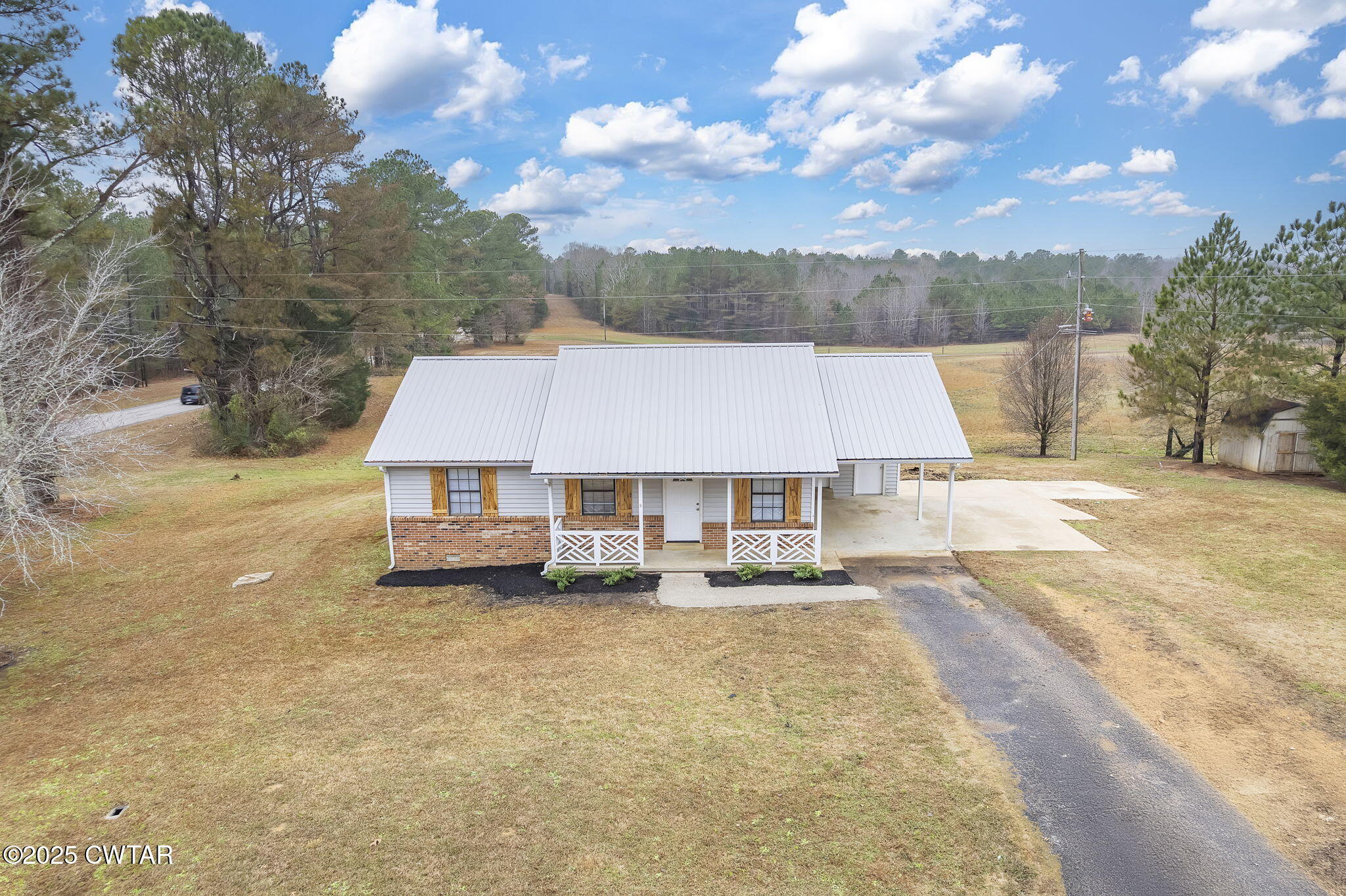 21 Carol Road Huron, TN 38345 - Photo 25 of 29 a tall house with a large tree next to it