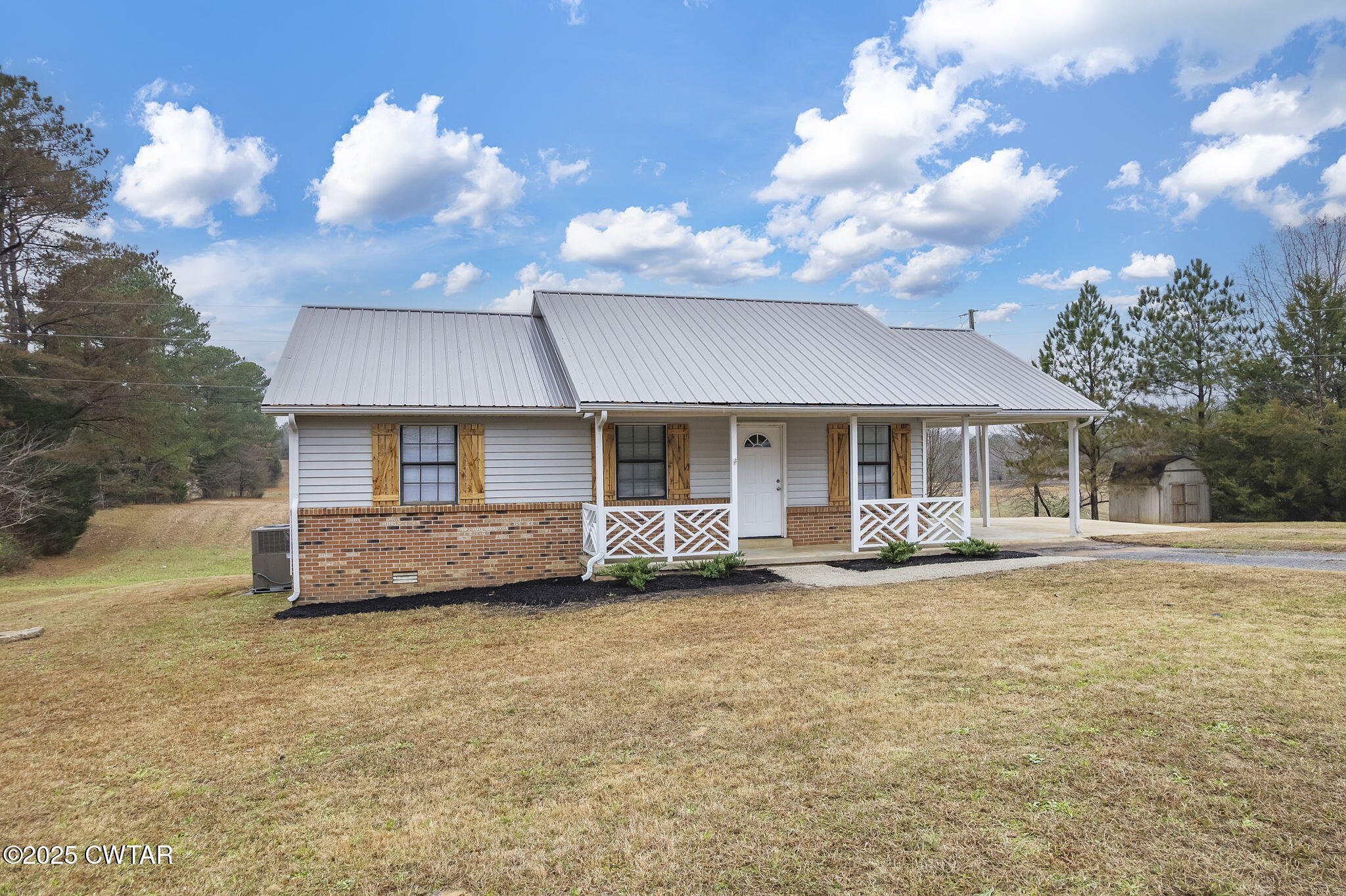 21 Carol Road Huron, TN 38345 - Photo 27 of 29 a view of a house with a yard and a fireplace
