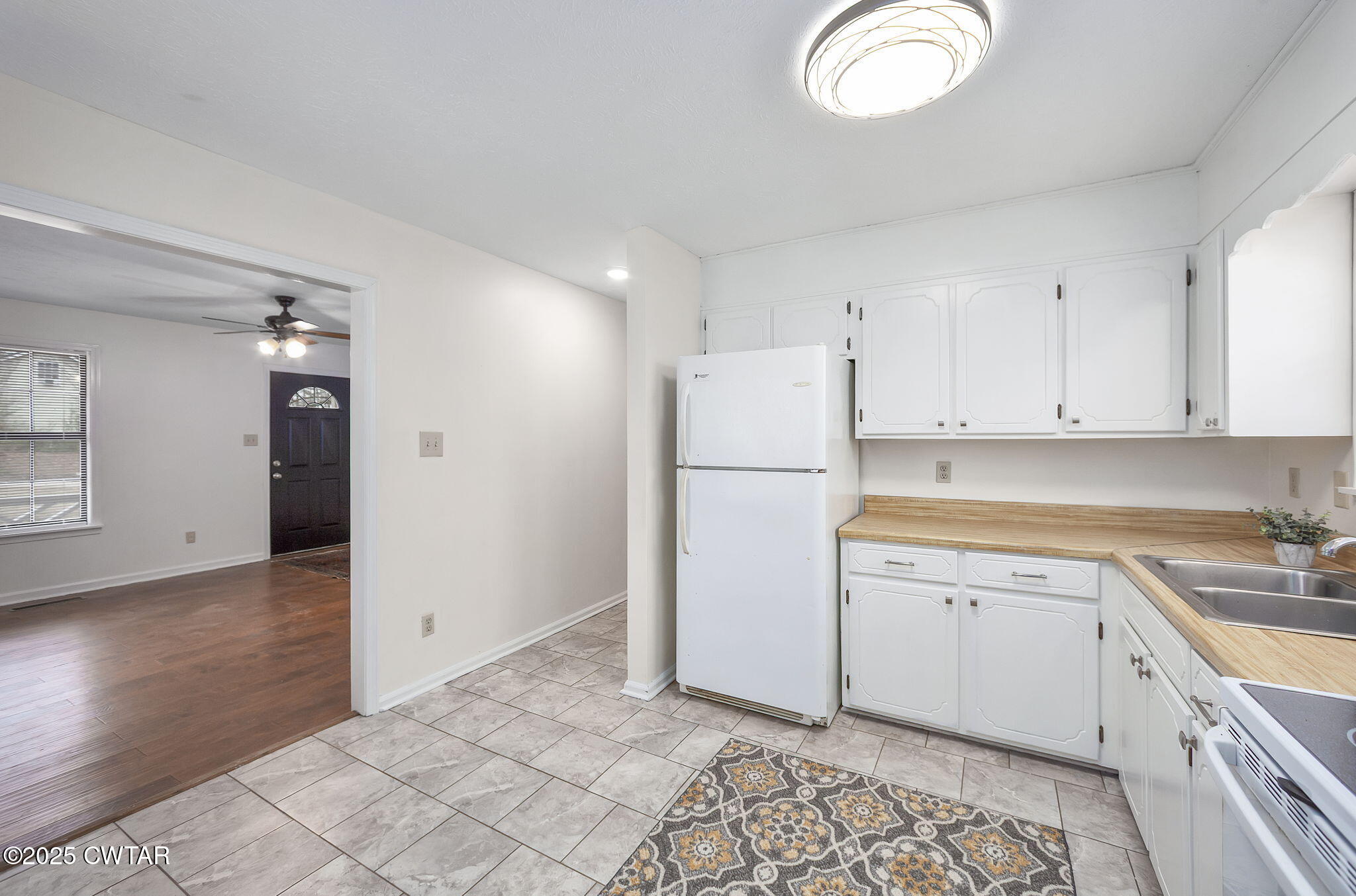 21 Carol Road Huron, TN 38345 - Photo 3 of 29 a kitchen with a refrigerator sink and cabinets
