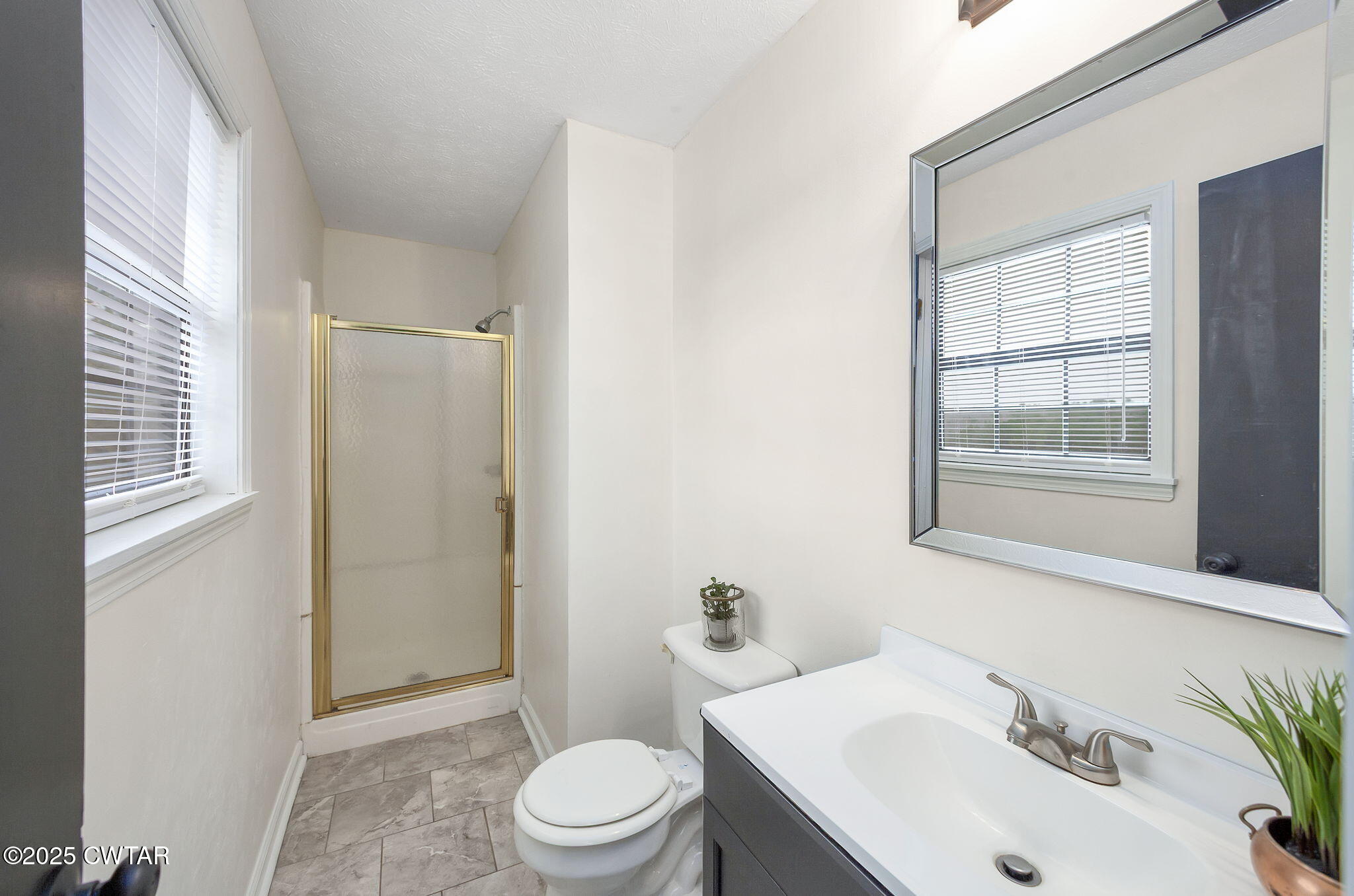 21 Carol Road Huron, TN 38345 - Photo 9 of 29 a bathroom with a sink a toilet and shower