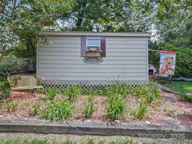 a view of a backyard with large trees