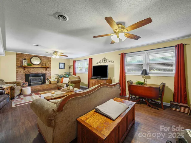a living room with furniture pool table and a fireplace