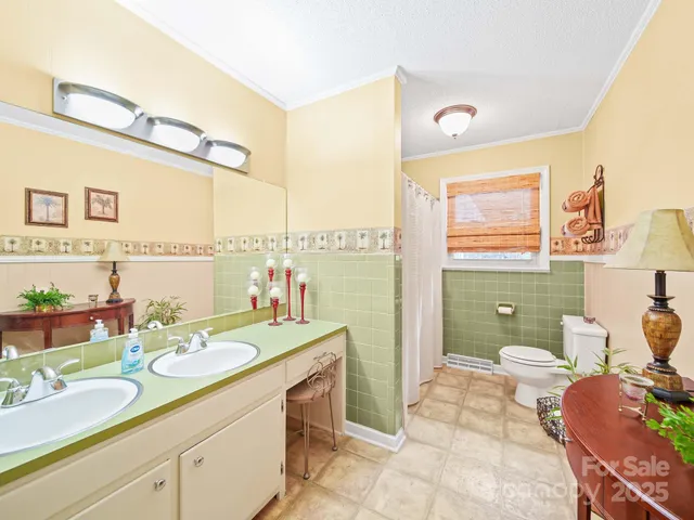 a bathroom with a granite countertop sink mirror vanity and toilet