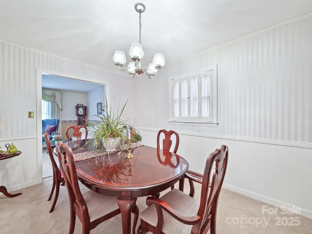 a view of a dining room with furniture and chandelier