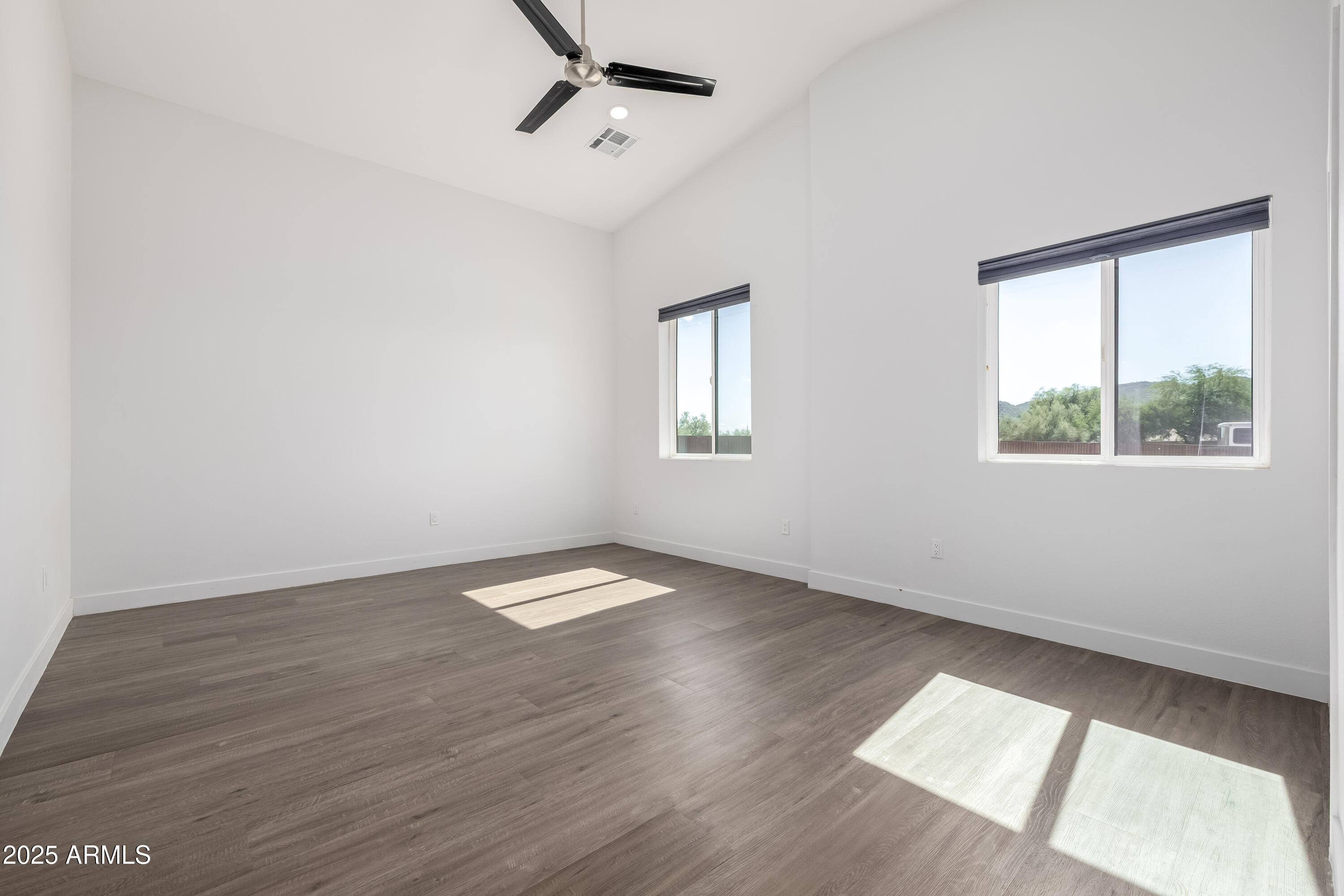 1807 West Joy Ranch Road Phoenix, AZ 85086 - Photo 26 of 49 an empty room with wooden floor and windows