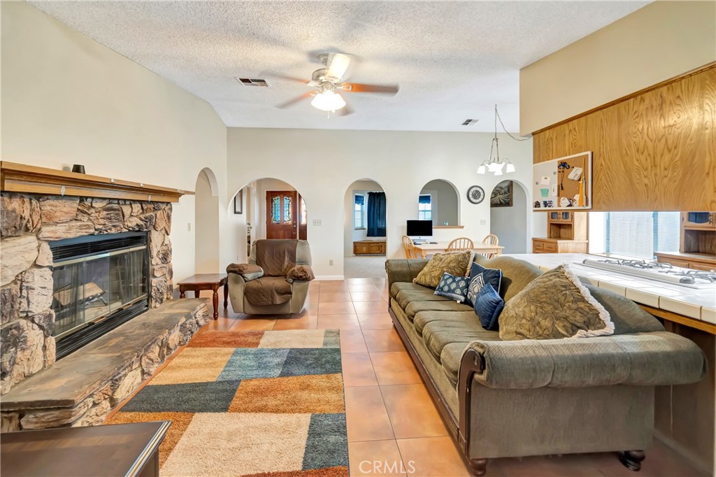 729 North Sunland Drive Ridgecrest, CA 93555 - Photo 11 of 52 a living room with furniture and a fireplace