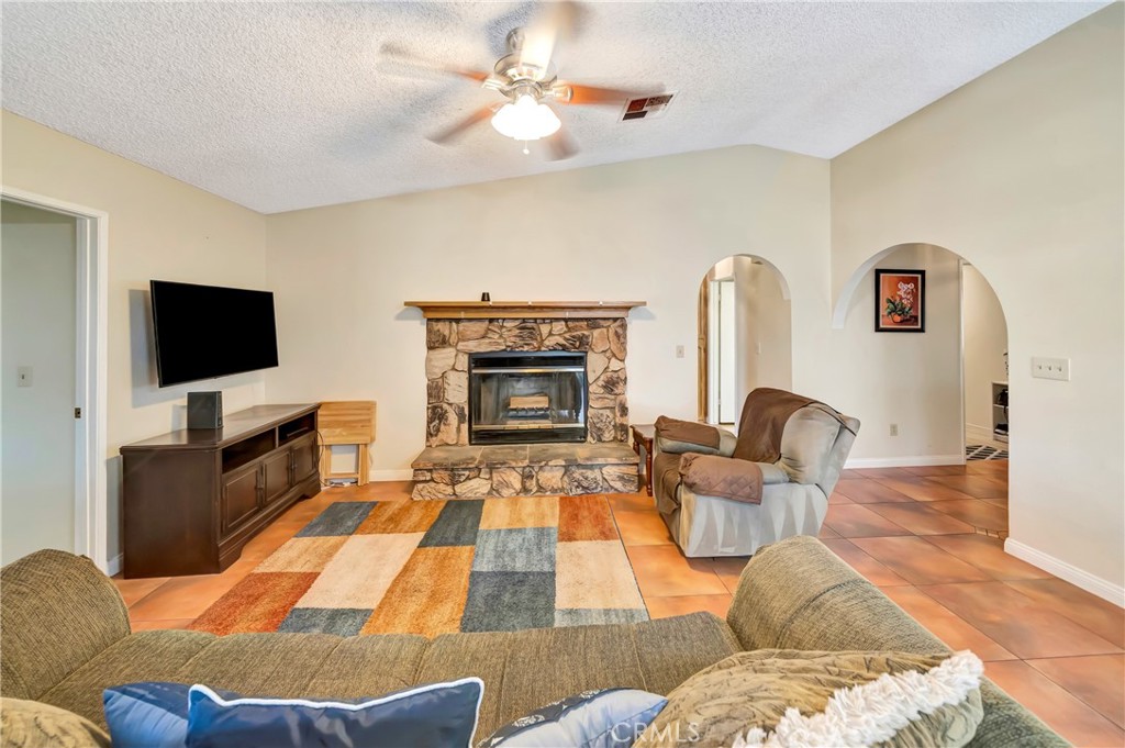 729 North Sunland Drive Ridgecrest, CA 93555 - Photo 12 of 52 a living room with furniture fireplace and flat screen tv
