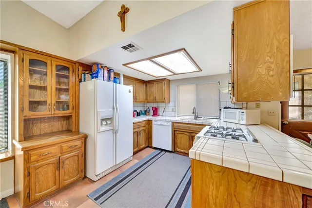 a kitchen with a refrigerator and a stove top oven