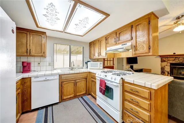 a kitchen with a stove a sink and a refrigerator