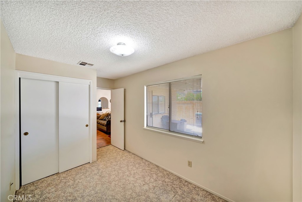 729 North Sunland Drive Ridgecrest, CA 93555 - Photo 21 of 52 an empty room with windows and closet