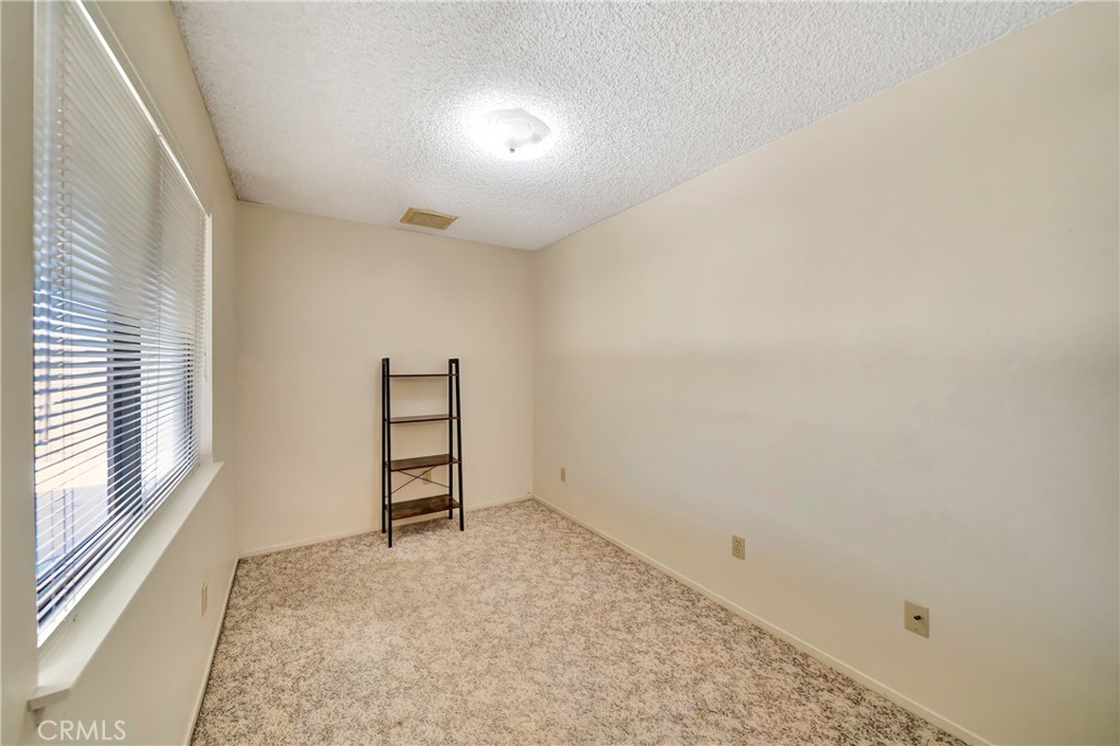 729 North Sunland Drive Ridgecrest, CA 93555 - Photo 22 of 52 an empty room with windows
