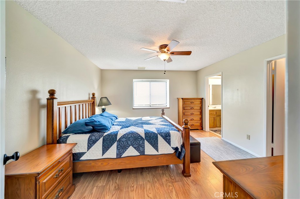 729 North Sunland Drive Ridgecrest, CA 93555 - Photo 24 of 52 a bedroom with furniture and wooden floor