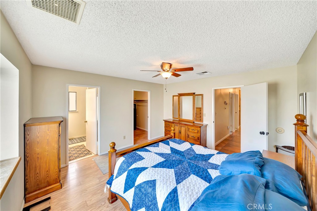 729 North Sunland Drive Ridgecrest, CA 93555 - Photo 26 of 52 a bedroom with a bed and wooden floor