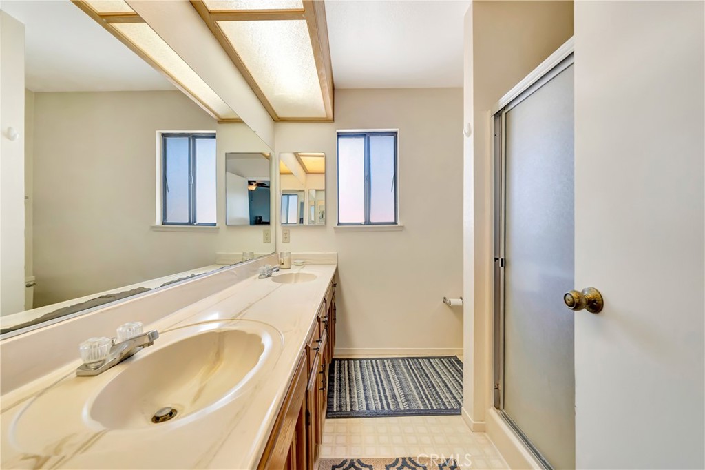 729 North Sunland Drive Ridgecrest, CA 93555 - Photo 28 of 52 a bathroom with a sink and mirror with toilet