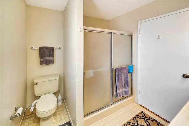 a bathroom with a toilet and a shower