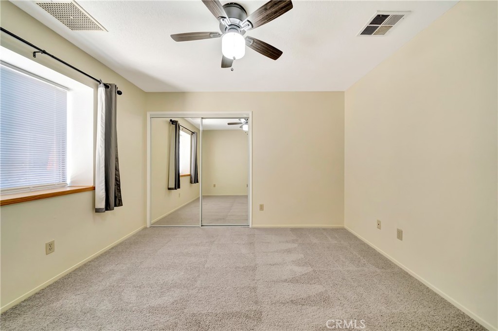 729 North Sunland Drive Ridgecrest, CA 93555 - Photo 35 of 52 an empty room with fan and windows