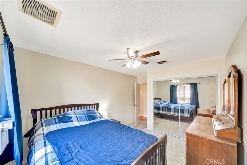 729 North Sunland Drive Ridgecrest, CA 93555 - Photo 38 of 52 a living room with a bed furniture and a window