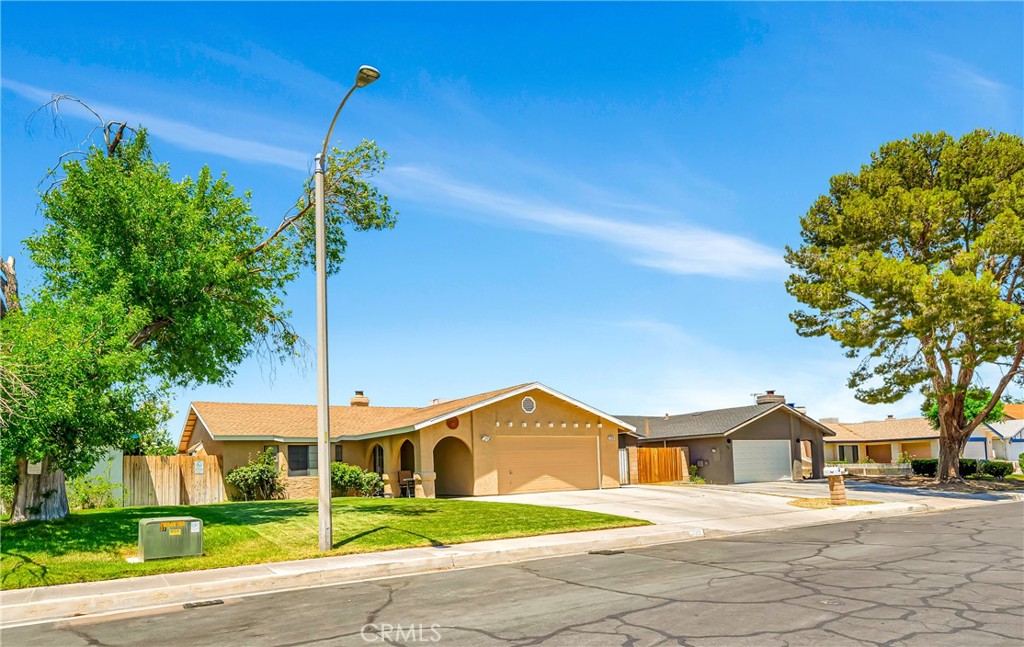 729 North Sunland Drive Ridgecrest, CA 93555 - Photo 51 of 52 a yellow and red house with a tree in front of it