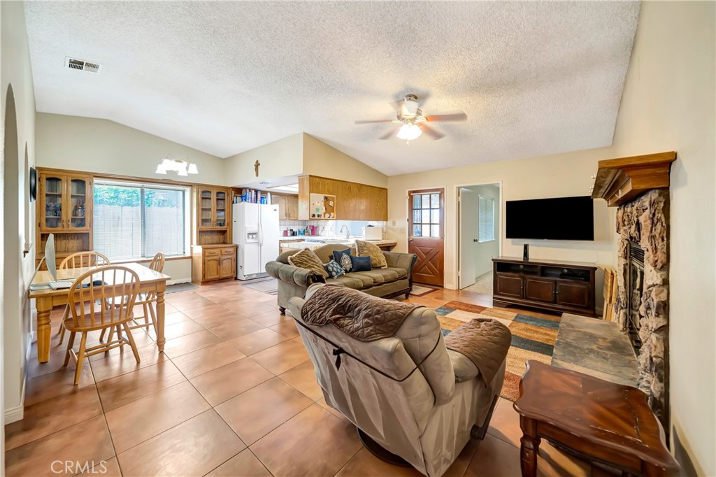 729 North Sunland Drive Ridgecrest, CA 93555 - Photo 8 of 52 a living room with furniture and a flat screen tv