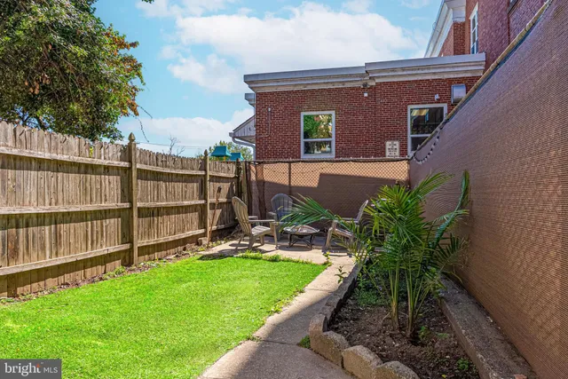 a front view of a house with a yard table and chairs
