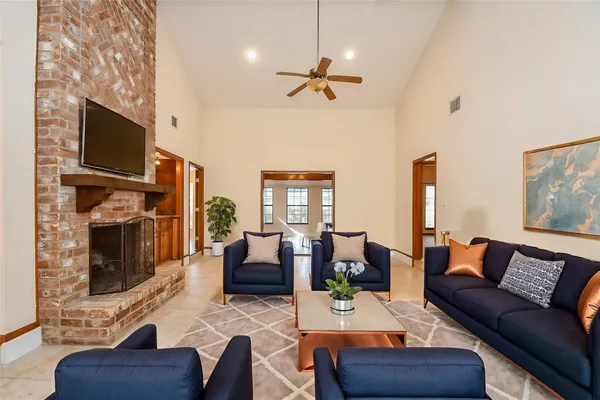 a living room with fireplace furniture and a flat screen tv