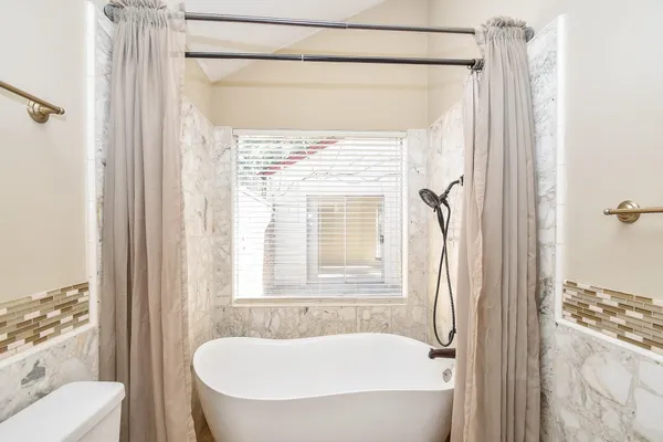 a bathroom with a tub and shower