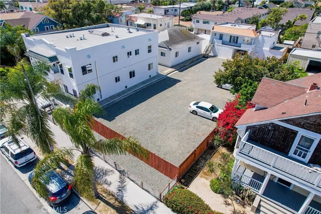 an aerial view of multiple houses with yard