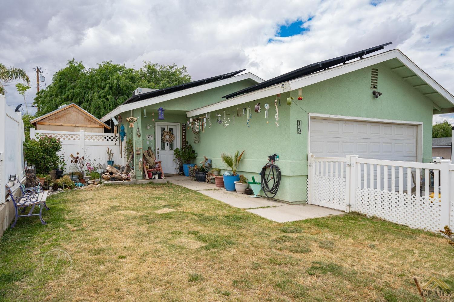 a view of backyard with a patio and a garden