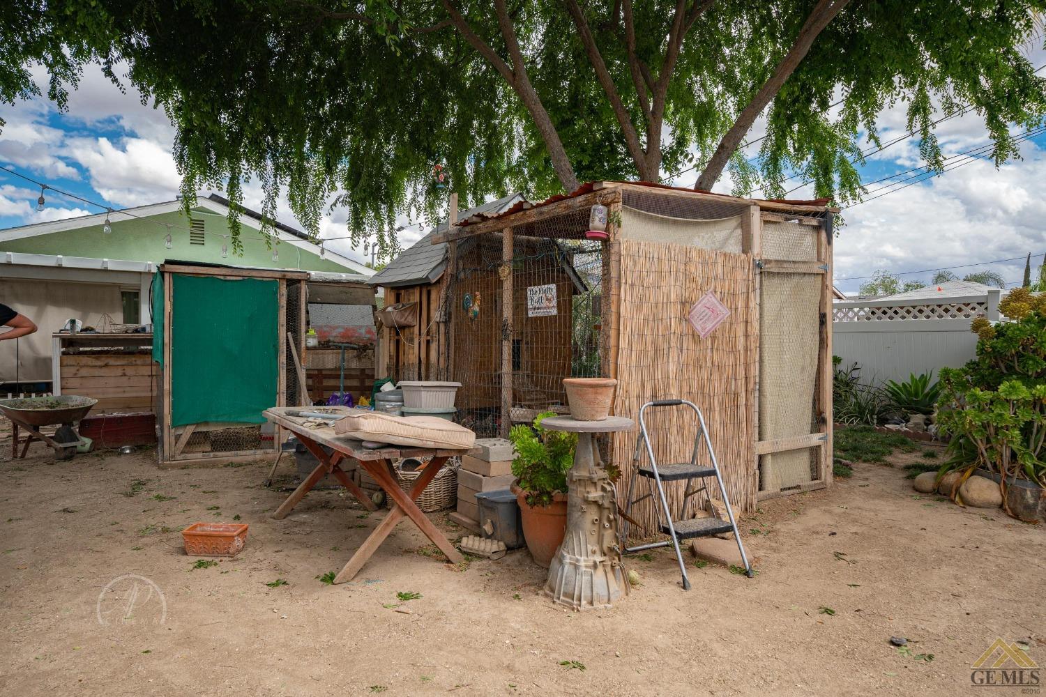 Undisclosed Address Taft, CA 93268 - Photo 18 of 21 a view of a patio with table and chairs under an umbrella