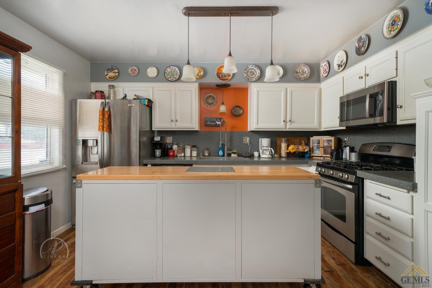 Undisclosed Address Taft, CA 93268 - Photo 5 of 21 a kitchen with stainless steel appliances granite countertop a sink and cabinets