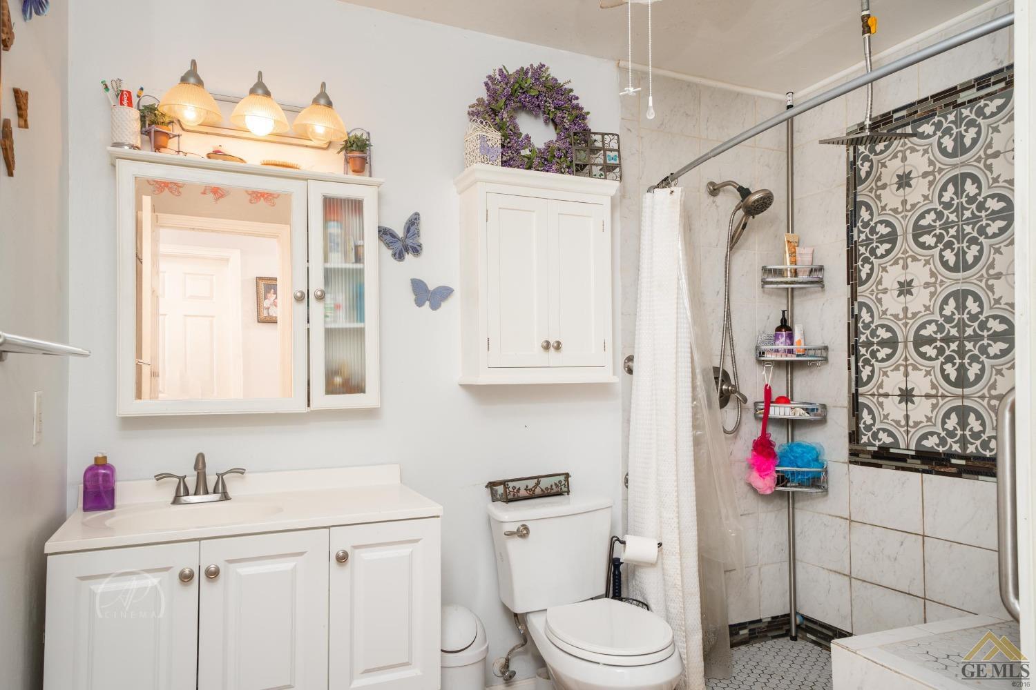 Undisclosed Address Taft, CA 93268 - Photo 8 of 21 a bathroom with a toilet sink and shower curtain