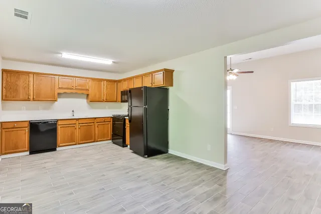 a kitchen with stainless steel appliances a refrigerator and a sink