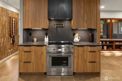 a kitchen with stainless steel appliances granite countertop a stove and a refrigerator