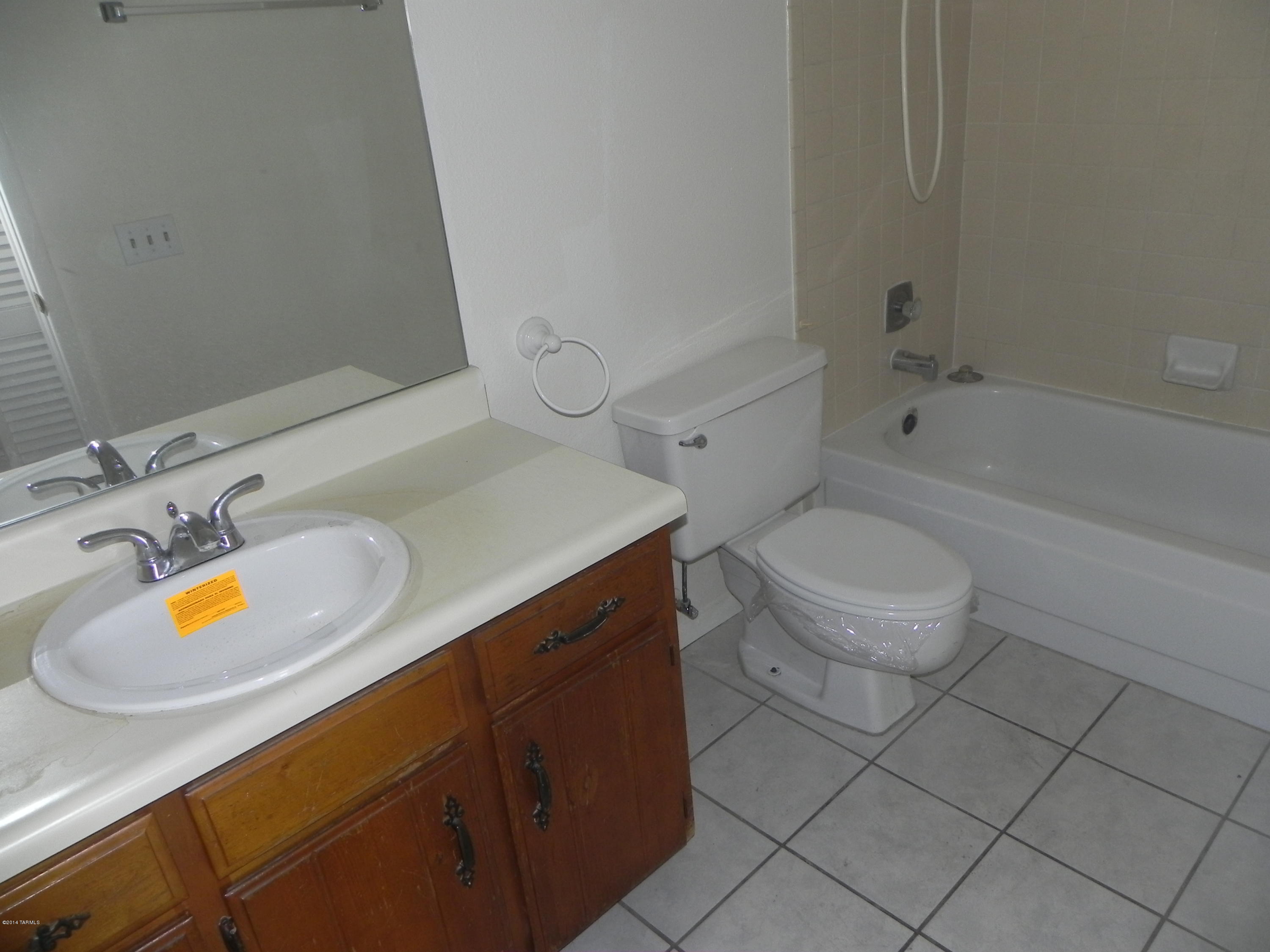 6625 East Golf Links Road, Unit 2 Tucson, AZ 85730 - Photo 9 of 14 a bathroom with a sink a toilet and bathtub