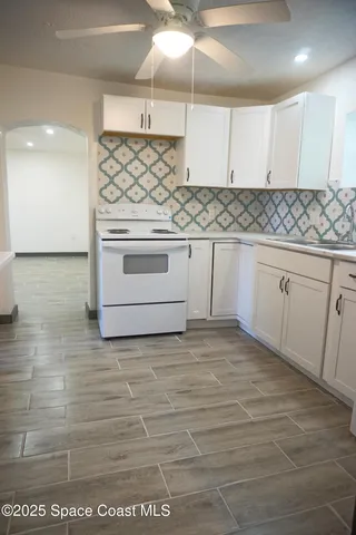 a kitchen with white cabinets stainless steel appliances and sink